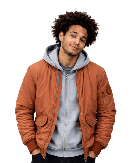 Man wearing a brown jacket over a gray hoodie on a white background