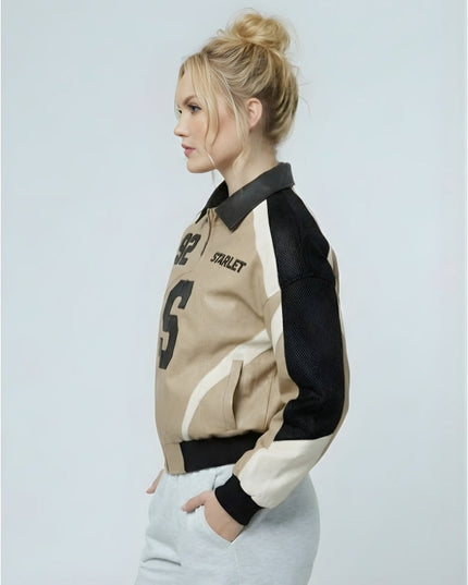 Woman wearing a beige and black varsity jacket with 'Starlet' branding on a light gray background