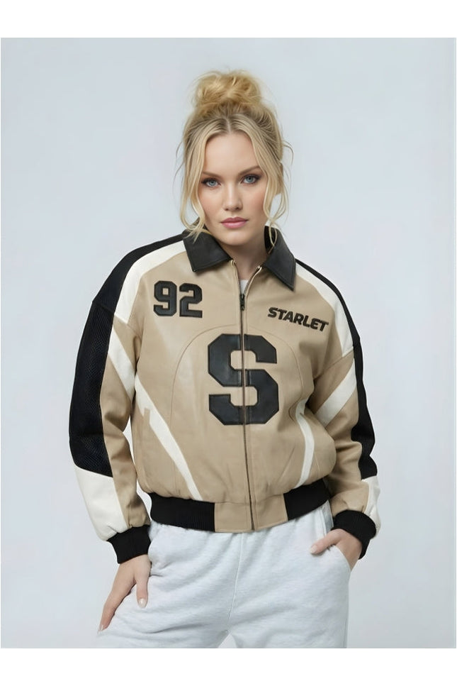 Woman wearing a beige and black jacket with '92' and 'STARLET' text on a light gray background