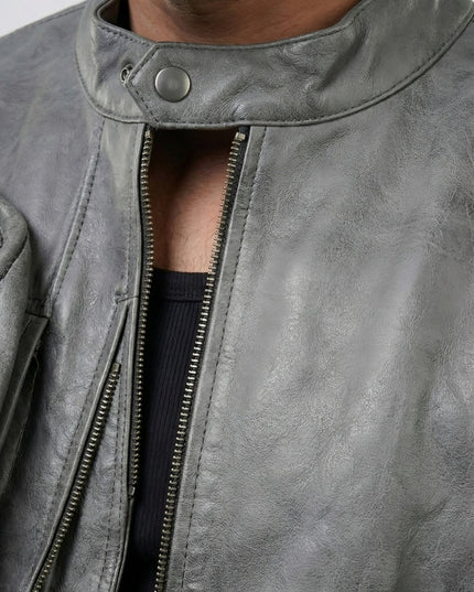 Close-up of a gray leather jacket with a zipper
