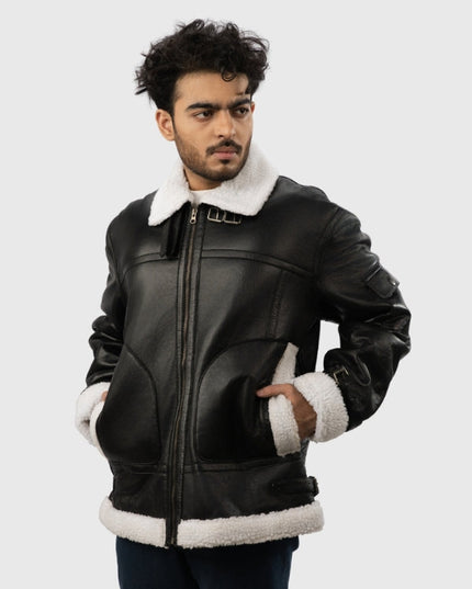 Man wearing a black leather jacket with white fur trim on a light gray background