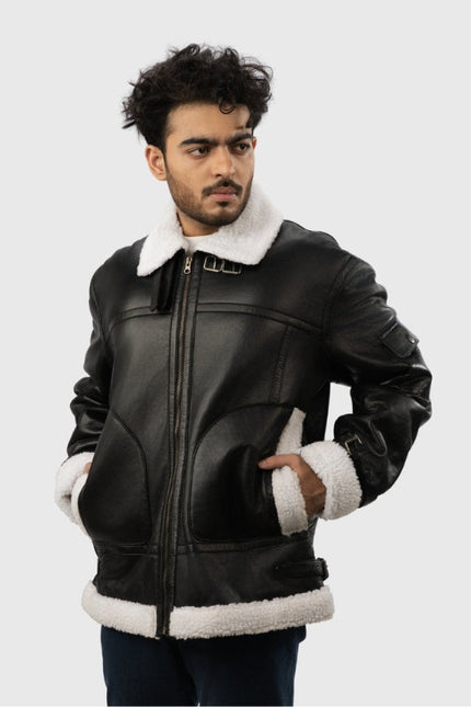 Man wearing a black leather jacket with white fur trim on a light gray background