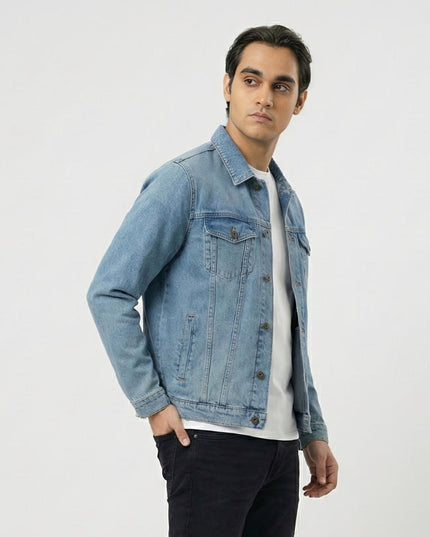 Man wearing a light blue denim jacket on a white background
