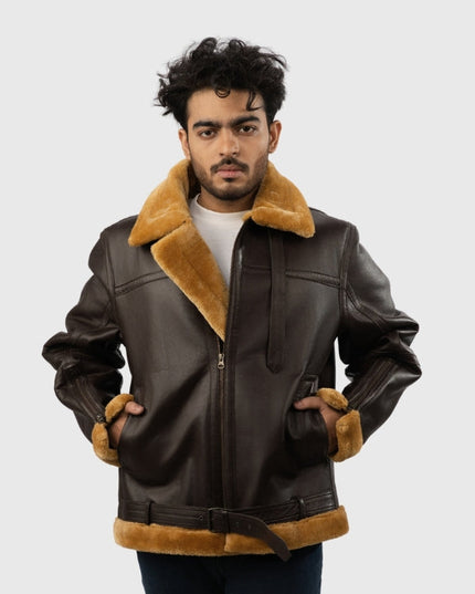 Man wearing a brown leather jacket with fur trim on a white background