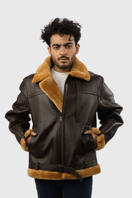 Man wearing a brown leather jacket with fur trim on a white background