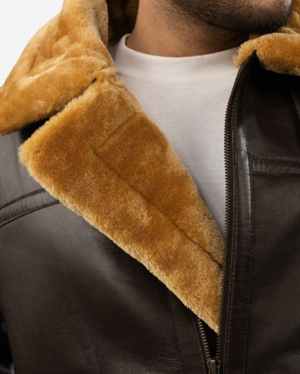 Close-up of a brown shearling jacket with a white shirt underneath.