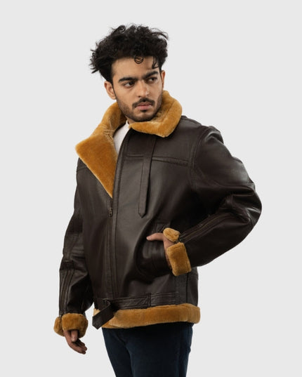 Man wearing a brown leather jacket with fur trim on a white background