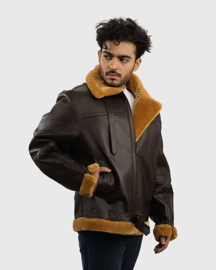 Man wearing a brown leather jacket with fur trim on a white background