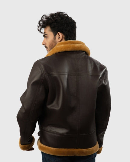 Man wearing a brown leather jacket with fur trim on a white background