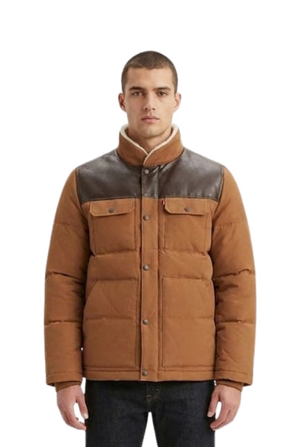 Man wearing a brown and gray quilted jacket on a white background