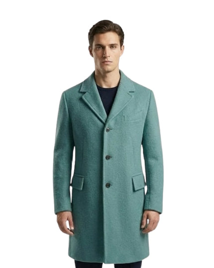 Man wearing a teal overcoat on a white background