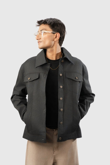 Man wearing a dark gray jacket on a light gray background