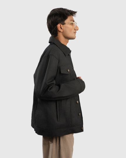 Person wearing a black coat on a white background