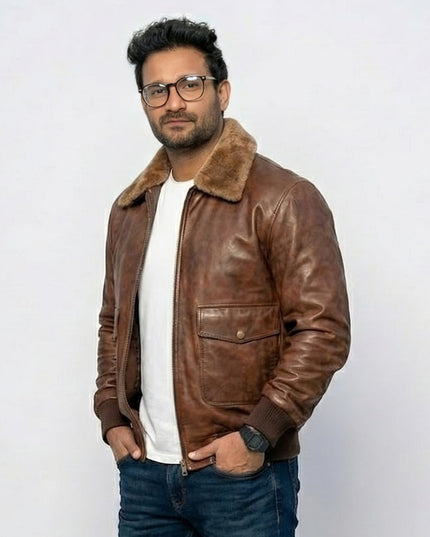 Man wearing a brown leather jacket with a fur collar on a white background