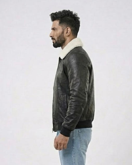 Man wearing a dark leather jacket with a white fur collar on a light gray background