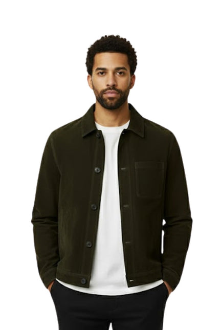 Man wearing a dark green jacket over a white shirt on a white background