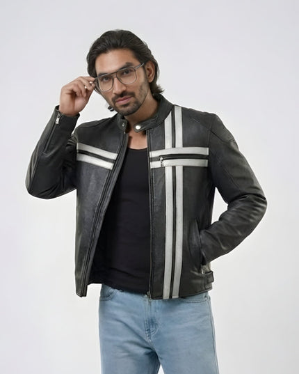 Man wearing a black leather jacket with white stripes, black shirt, and light blue jeans on a white background