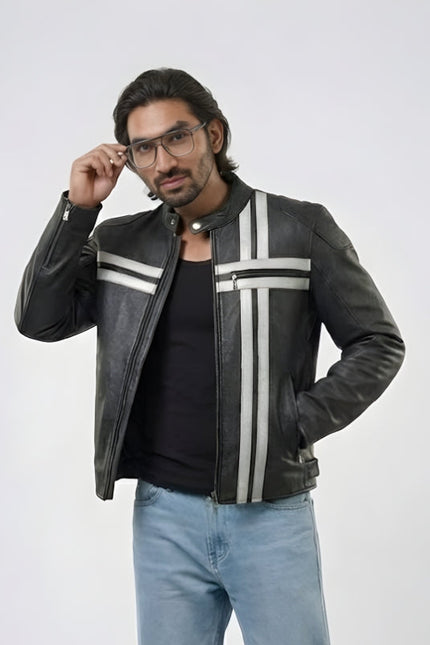 Man wearing a black leather jacket with white stripes, black shirt, and light blue jeans on a white background