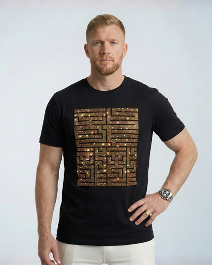 Man wearing a black t-shirt with a unique design on a plain background