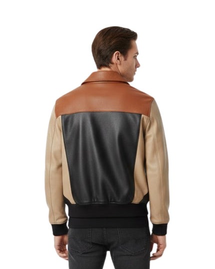 Man wearing a two-tone leather jacket with brown and beige sections on a white background