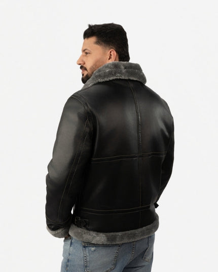Man wearing a black leather jacket with gray fur lining on a white background