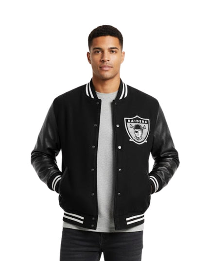 Man wearing a black varsity jacket with a logo on a white background