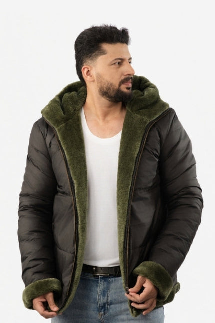 Man wearing a dark green puffer jacket with olive green hood and cuffs on a white background