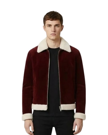 Man wearing a burgundy jacket with white trim on a white background