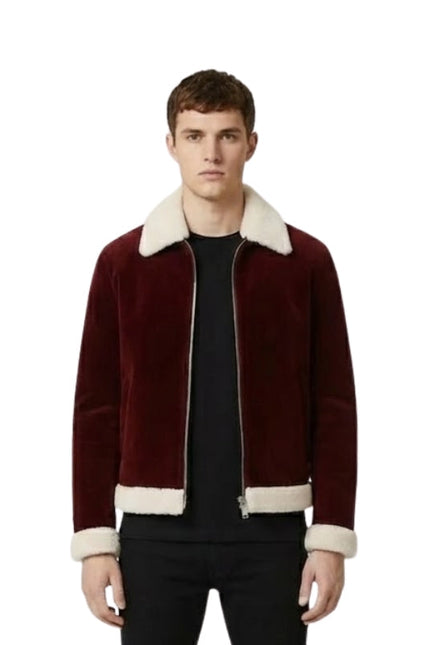 Man wearing a burgundy jacket with white trim on a white background