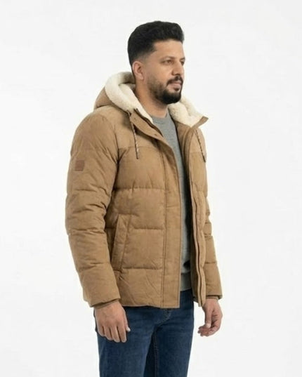 Man wearing a brown puffer jacket with a white background