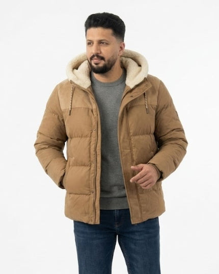 Man wearing a brown puffer jacket with a white hood on a white background