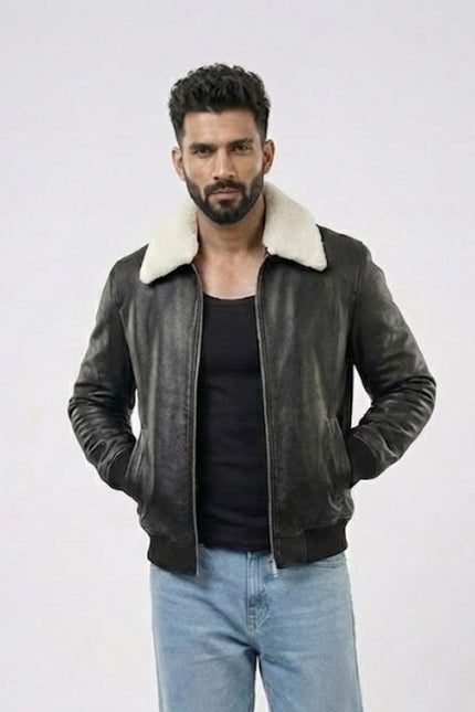 Man wearing a dark leather jacket with white fur lining on a light gray background