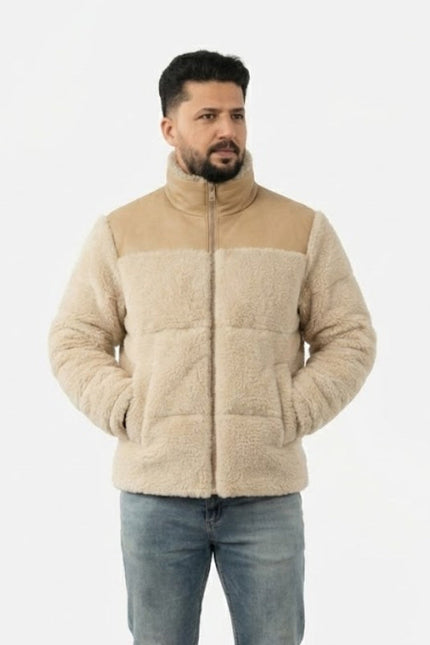 Man wearing a beige quilted jacket on a white background