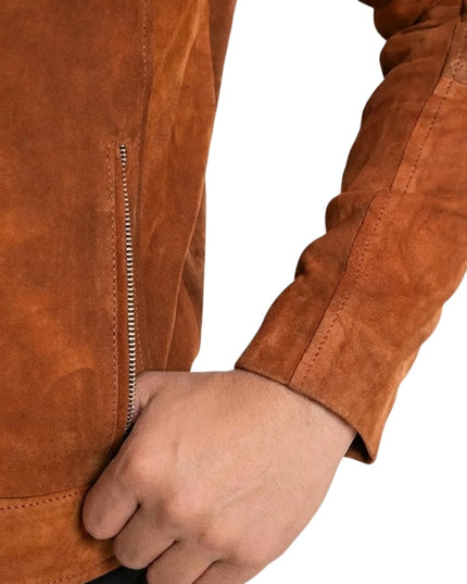 Close-up of a brown suede jacket with a hand holding a handle.