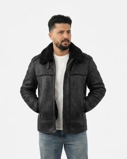 Man wearing a black leather jacket with fur collar on a white background