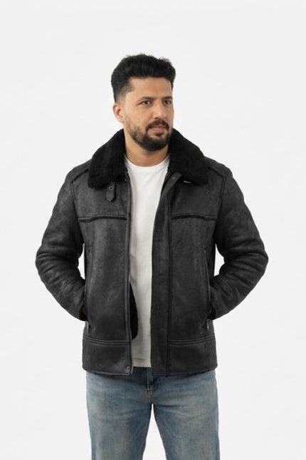 Man wearing a black leather jacket with fur collar on a white background