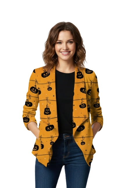 Woman wearing a yellow cardigan with black pumpkin patterns on a white background