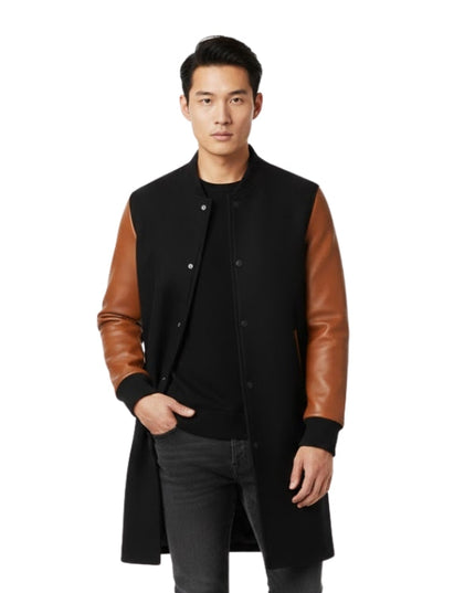 Man wearing a black coat with brown leather sleeves on a white background