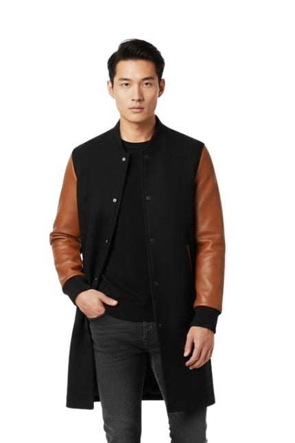 Man wearing a black coat with brown leather sleeves on a white background