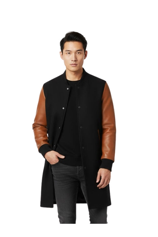 Man wearing a black coat with brown leather sleeves on a white background