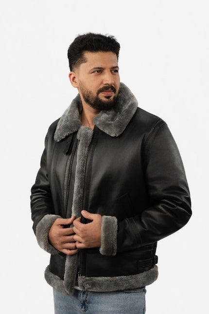 Man wearing a black leather jacket with gray fur lining on a white background