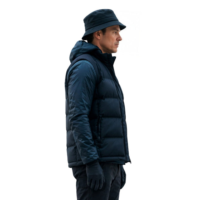 Person wearing a dark blue puffer jacket and hat on a white background