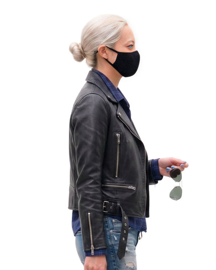 Woman wearing a black leather jacket and face mask on a white background