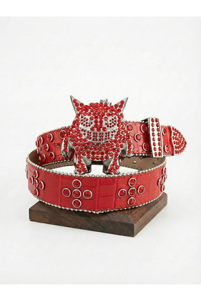 Red belt with a decorative buckle on a white background
