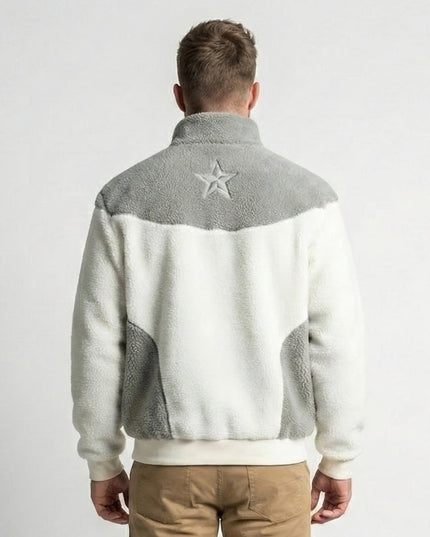 Person wearing a gray and white jacket with a star emblem on the back against a white background