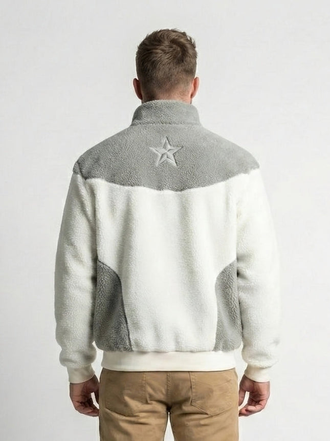 Person wearing a gray and white jacket with a star emblem on the back against a white background