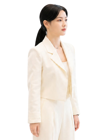 Woman wearing a light-colored suit on a white background