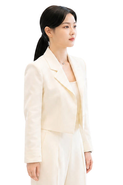 Woman wearing a light-colored suit on a white background