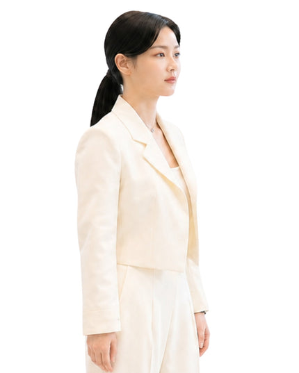 Woman wearing a light-colored suit on a white background