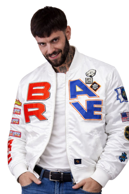 Man wearing a white bomber jacket with colorful text and patches on a white background